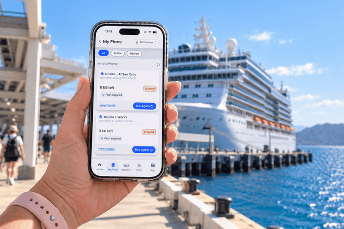 Lady holding a phone with GigSky eSIMs installed with cruise ship in background