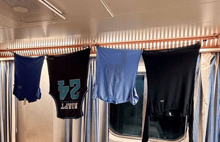 Freshly washed laundry hanging inside a cruise cabin